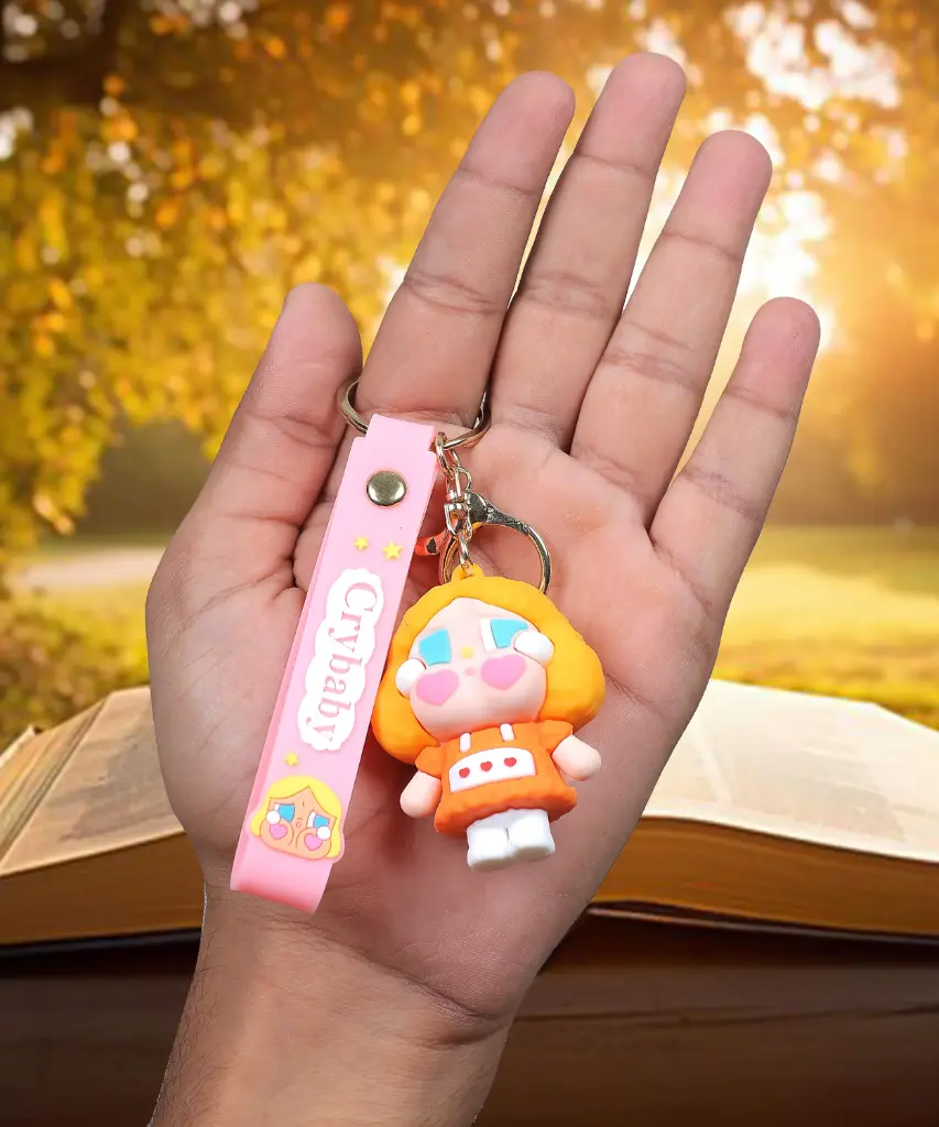Orange Crybaby Doll Figure Keychain with Yellow Hood | "Crybaby" Logo Wrist Strap Accessory | Trendy Collectible Key Ring
